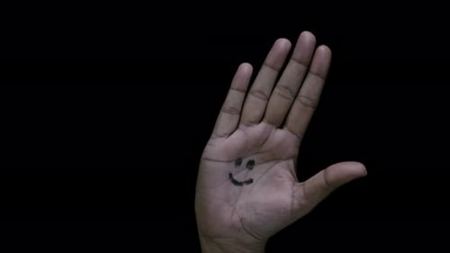 Hand Opens to Show Smiley Face Drawing