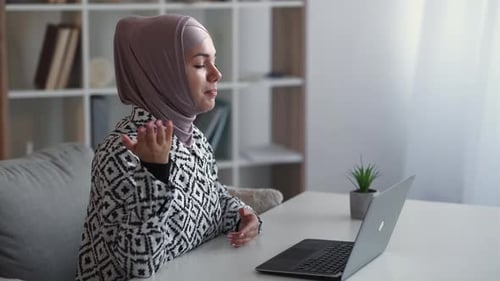 Woman Video Calling Using Laptop in Bright Room