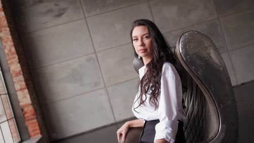 Woman Poses in Modern Chair by Window