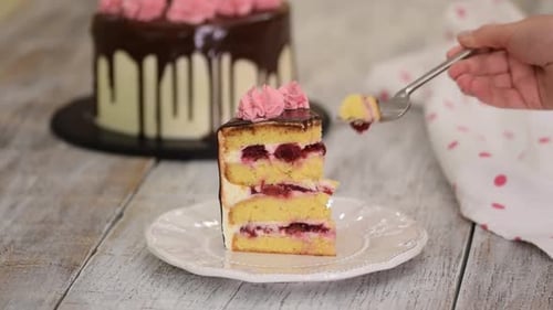 Cake Slice on Plate Being Pierced by Fork