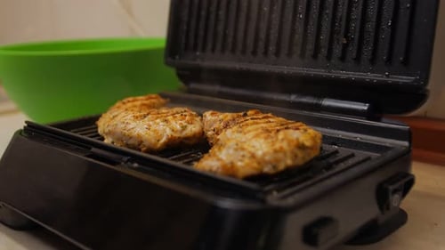 Chicken Breast Grilling on Black Indoor Grill