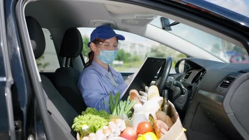 Stay at Home, Young Girl in Medical Mask and Gloves Works As Courier in Delivery Service and Checks