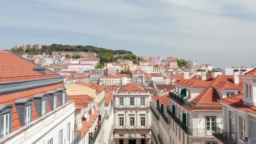 Aerial Dolly in View of Colorful Traditional European Houses with Orange Rooftops and Old Castle on