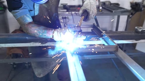 Factory male worker producing metal construction