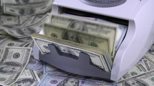 Money Counting Machine Counts One Hundred Dollar Bills