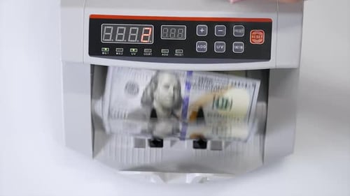 Money counting machine with 100 dollar banknotes. US national paper currency. Bank automatic equipme