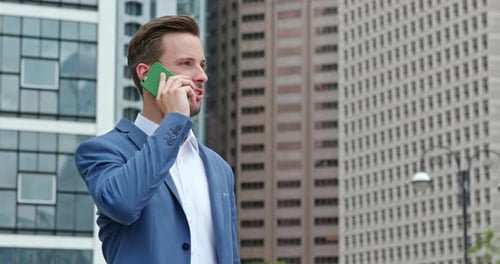 Confident Man in Blazer Talking on Phone in City