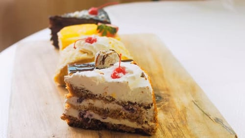 Assorted Cake Slices on Wooden Cutting Board