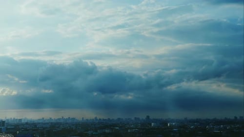 Clouds Rolling Over City Buildings at Sunset