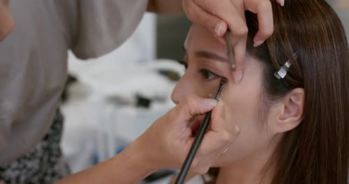 Makeup Artist Applying Detailed Eye Makeup on Woman