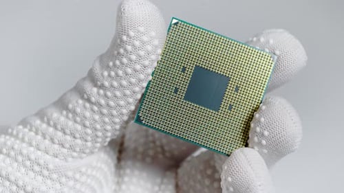 CPU. A Laboratory Technician Holds a Powerful Processor in His Hands