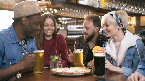 Company of Multi Ethnic Friends Resting in the Bar, Pub