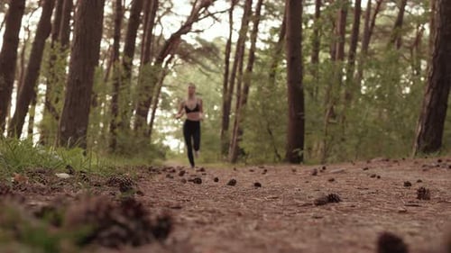 Young Woman Jogging in the Forest
