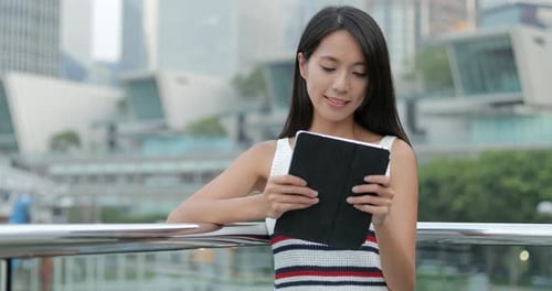 Woman Using Digital Tablet Computer in The City