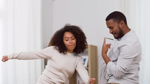 Happy Couple Dancing and Celebrating at Home