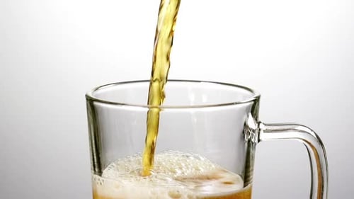 Beer Pouring into a Glass Beer Mug