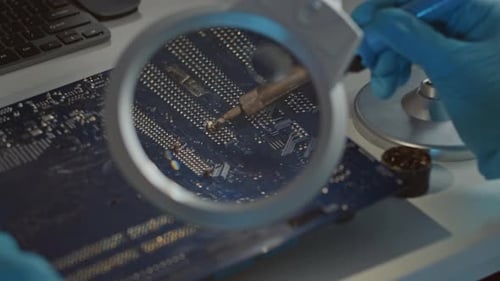 Soldering Iron Repairs Computer Circuit Board Close Up