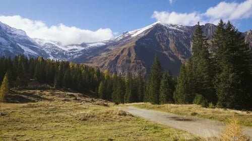 Majestic Mountains and Rural Landscape Under Blue Sky