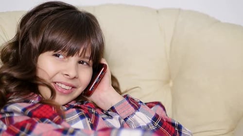 Smiling Girl Talking on Smartphone Indoors