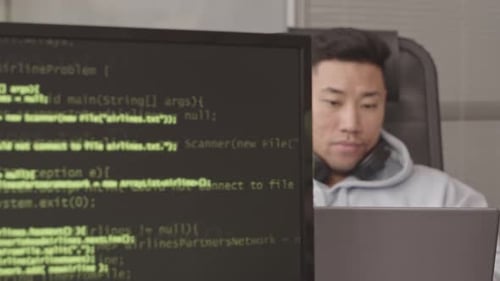 Asian Programmer Coding in Office
