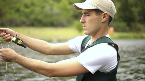Man Fishing at a Lake During the Day