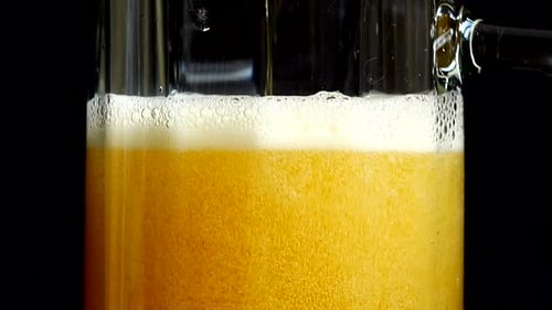 Beer Being Poured Into Glass Mug Close Up
