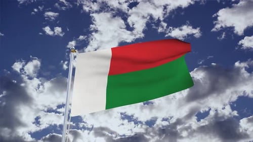 Madagascar Flag Waving Against Blue Sky with Clouds