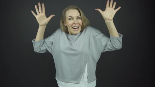 Smiling Woman with Hands Up in Celebration