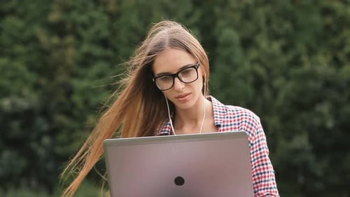 Girl Uses Laptop in Park