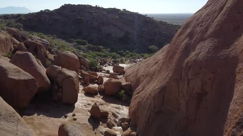 Huge rocky mountain and a mountain covered in plants in Erongo, Namibia