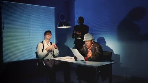 Police Interrogation with Suspect in Dark Room