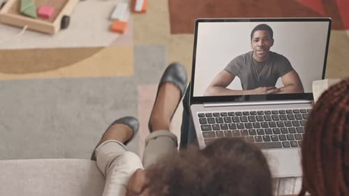 Family Video Calling Smiling Man on Laptop