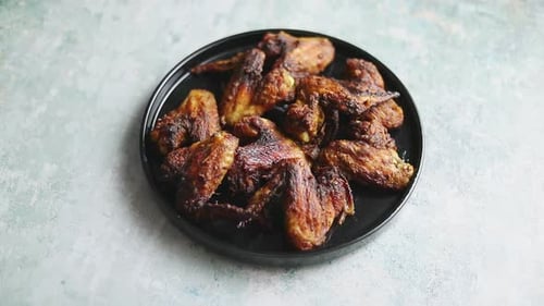 Golden Brown Grilled Chicken Wings on a Plate