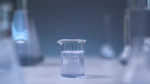 Beaker with Clear Liquid in Laboratory Setting