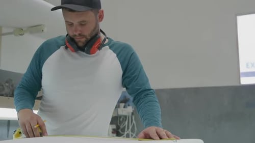 Male surfboard maker in his workshop