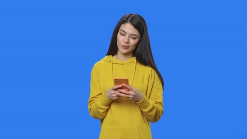 Woman Using Smartphone on Blue Chroma Key Background