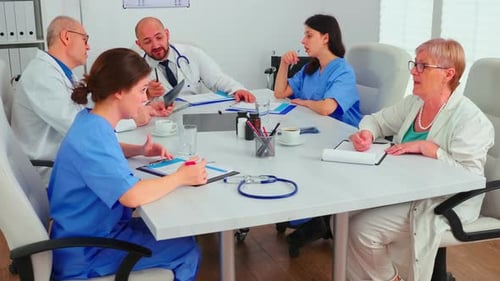 Medical Professionals Meeting at Conference Table in Hospital