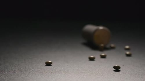 Pills Spilling from Medicine Bottle in Slow Motion
