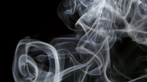 White Smoke Flowing on Black Background
