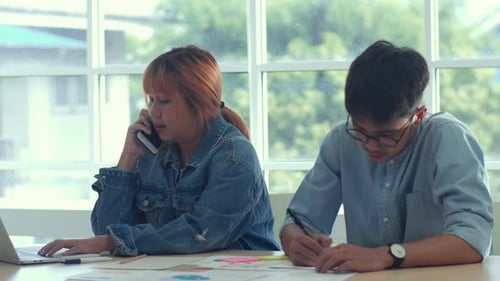 Group of business man and woman using mobile phone talking with customer at office.