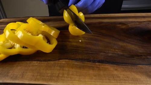 Slicing Yellow Bell Pepper Rings on Cutting Board
