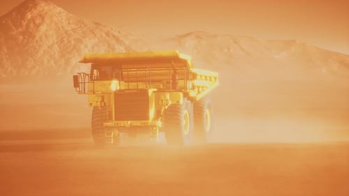 Giant Yellow Mining Dump Truck Driving Through a Dusty Desert