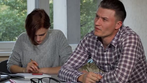 Male Student Taking Off His Glasses, Looking Tired While Studying
