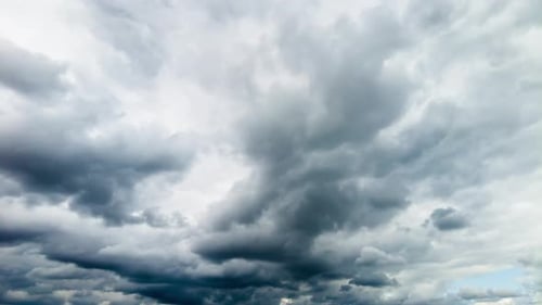 Storm clouds give way to white and blue skies, time lapse