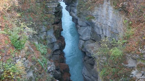Breathtaking View on Deep Cleft Between Rocks with River