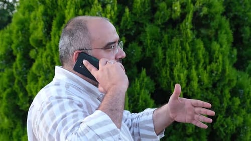 Man Talking on Mobile Phone Outdoors