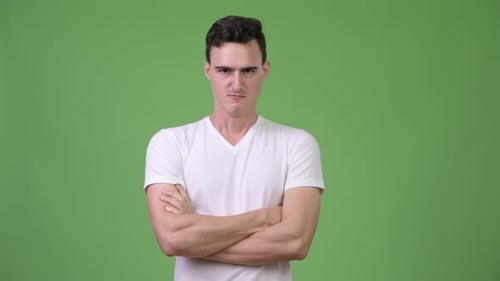 Angry Young Adult Man with Arms Crossed