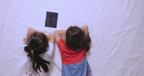 Little Girls With Tablet On The Floor