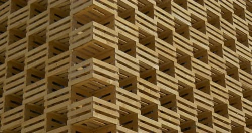 Wooden Crates Stacked Forming Building With Blue Sky