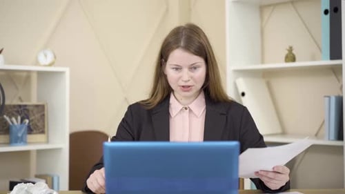 Young Woman Video Conferencing in Workplace